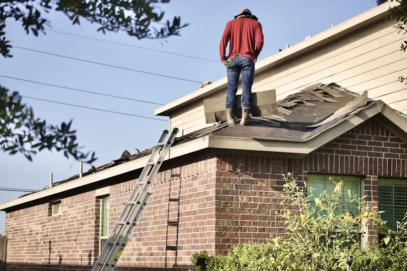 Professional roofer working on a residential roof in Wiley Shelter